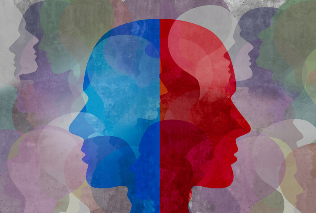 Two side profiles of heads are back to back. One is red, the other is blue.