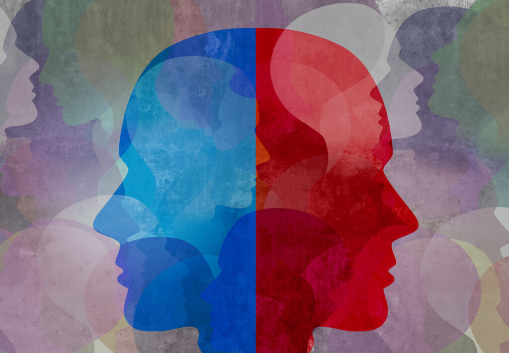 Two side profiles of heads are back to back. One is red, the other is blue.