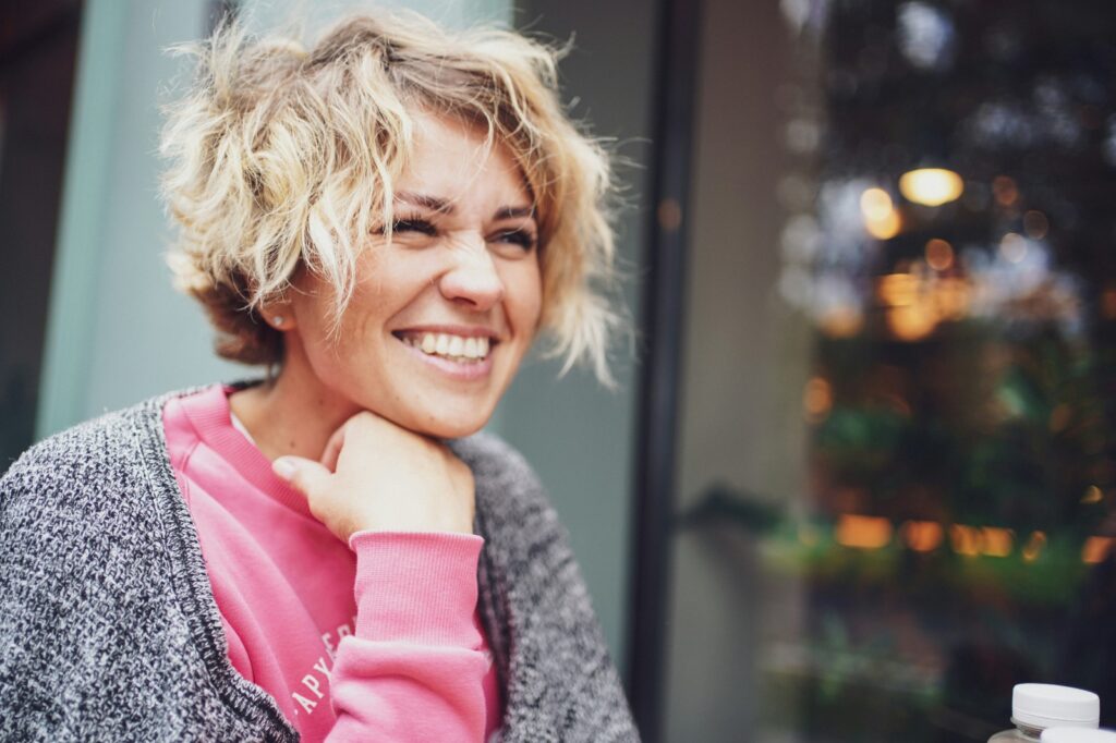 A woman with short hair smiles at the camera