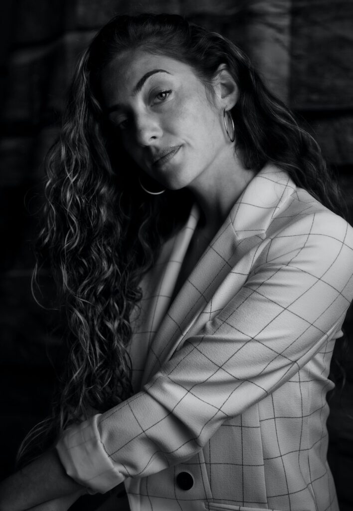 Portrait photo of a business woman wearing a blazer looking at the camera